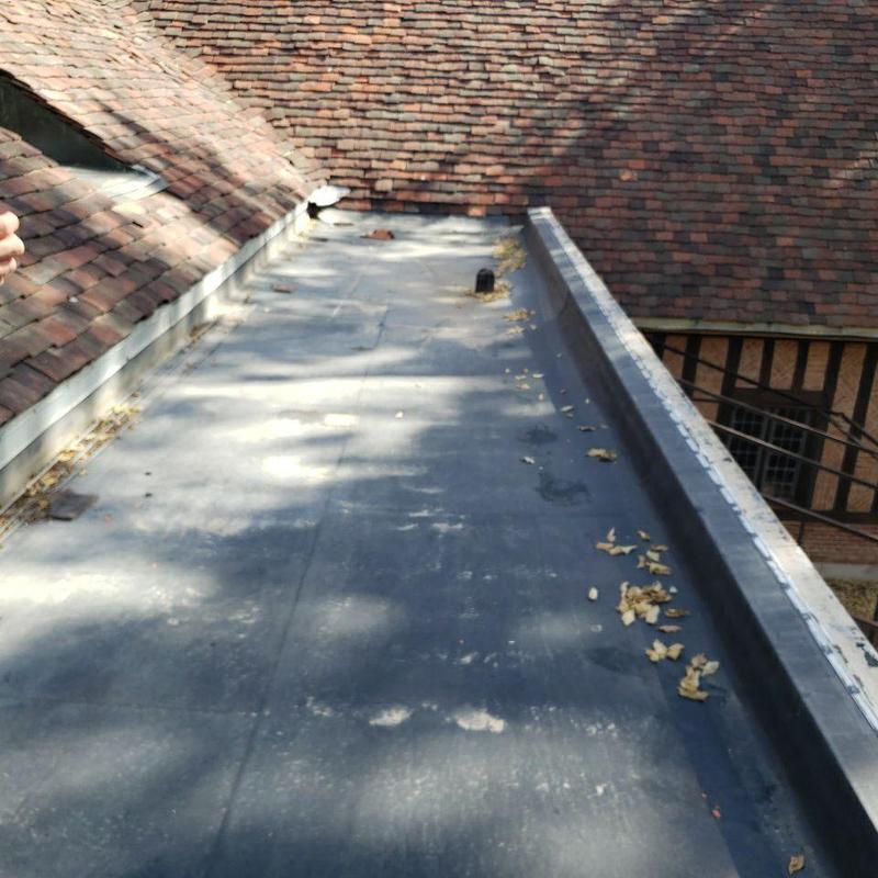 Flat roof with leaking roof drains and debris