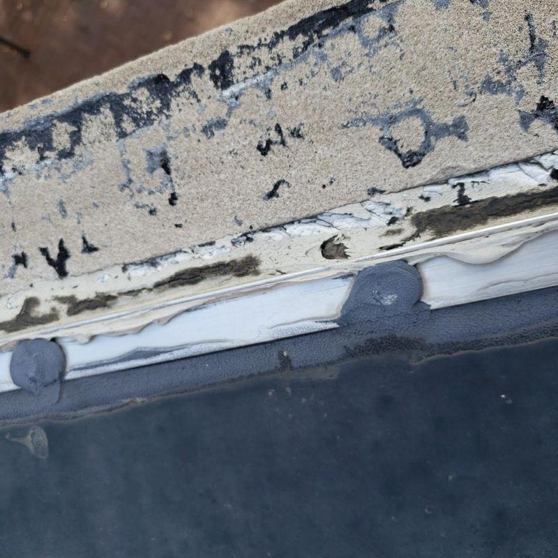 Roof drain sealant and flat roof membrane close-up