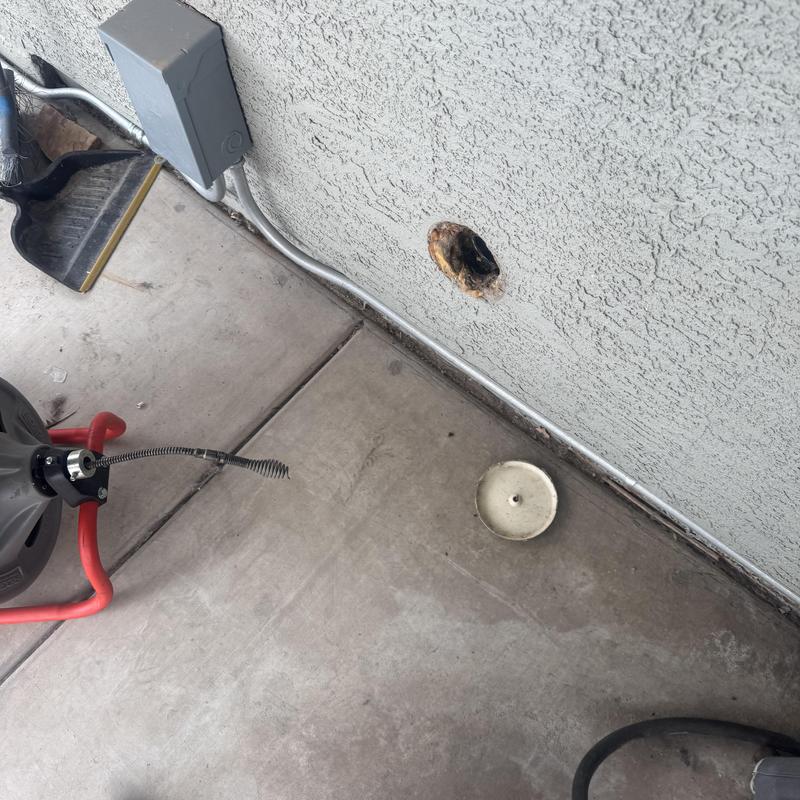 Sewer line cleaning with drain snake on exterior wall