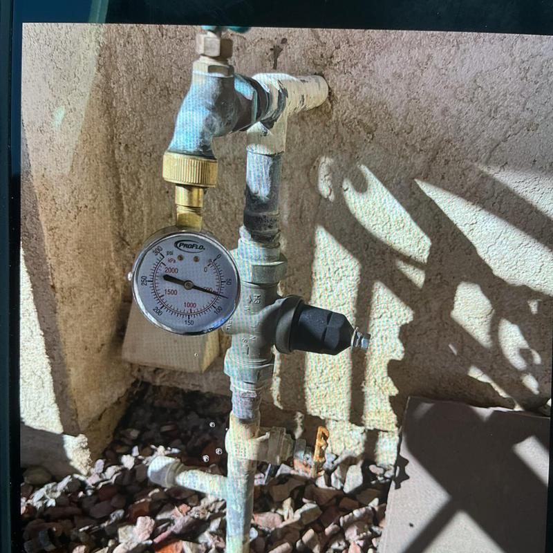 Pressure regulator valve with gauge on outdoor water pipe
