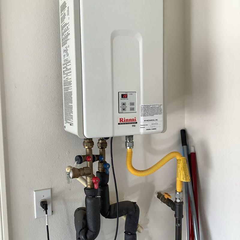 Tankless water heater with flush valves and piping
