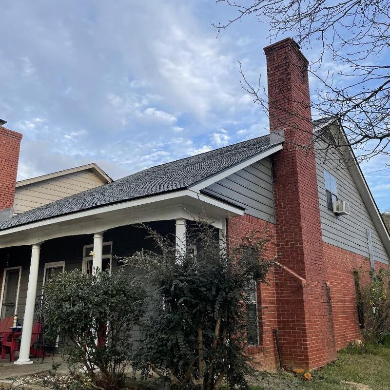 Architectural shingle roof installation on residential house Architectural shingle roof installation on residential house