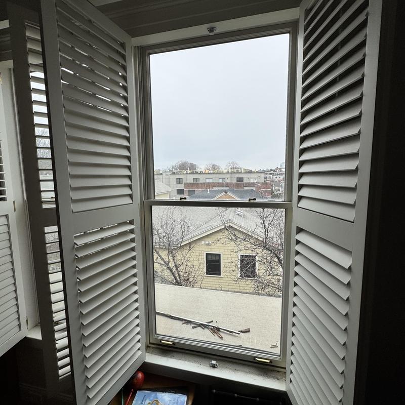 Andersen window replacement with white shutters