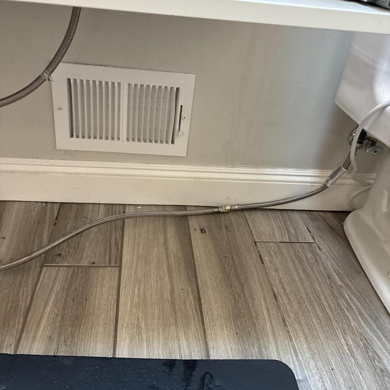 Toilet water supply line with dual angle stop installed