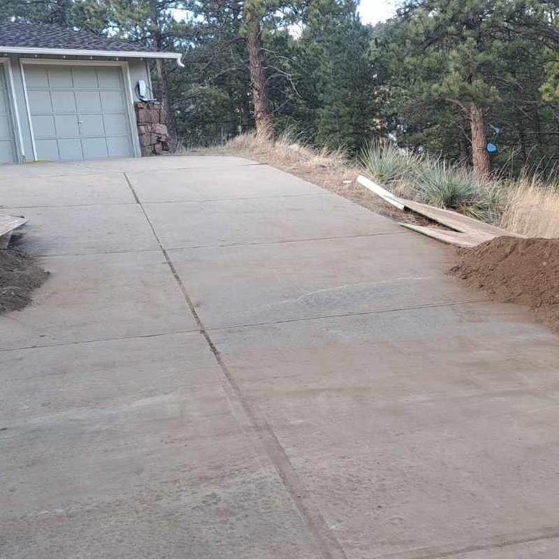 HDPE sewer pipe installation along concrete driveway