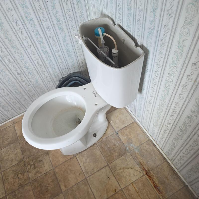 Toilet assembly with tank removed for flange repair