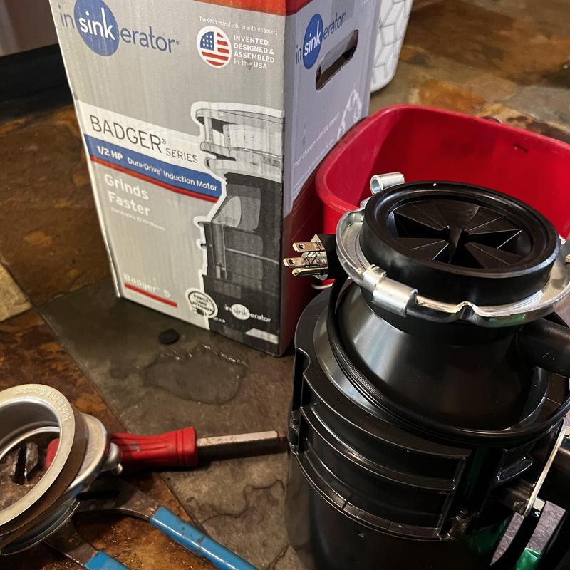 Garbage disposal unit and installation tools on floor
