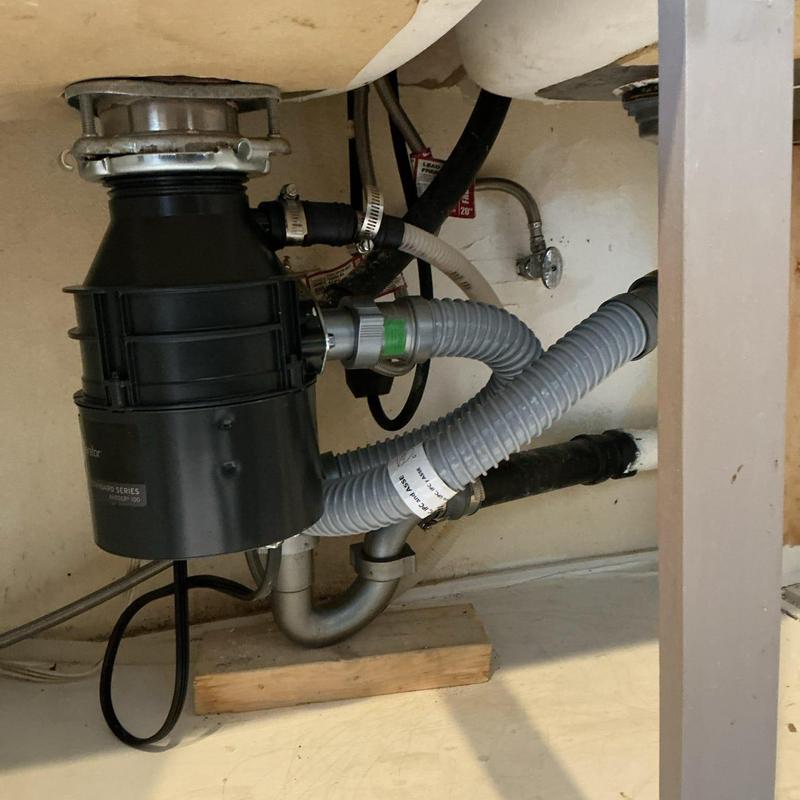 Garbage disposal and drain pipes under sink installation