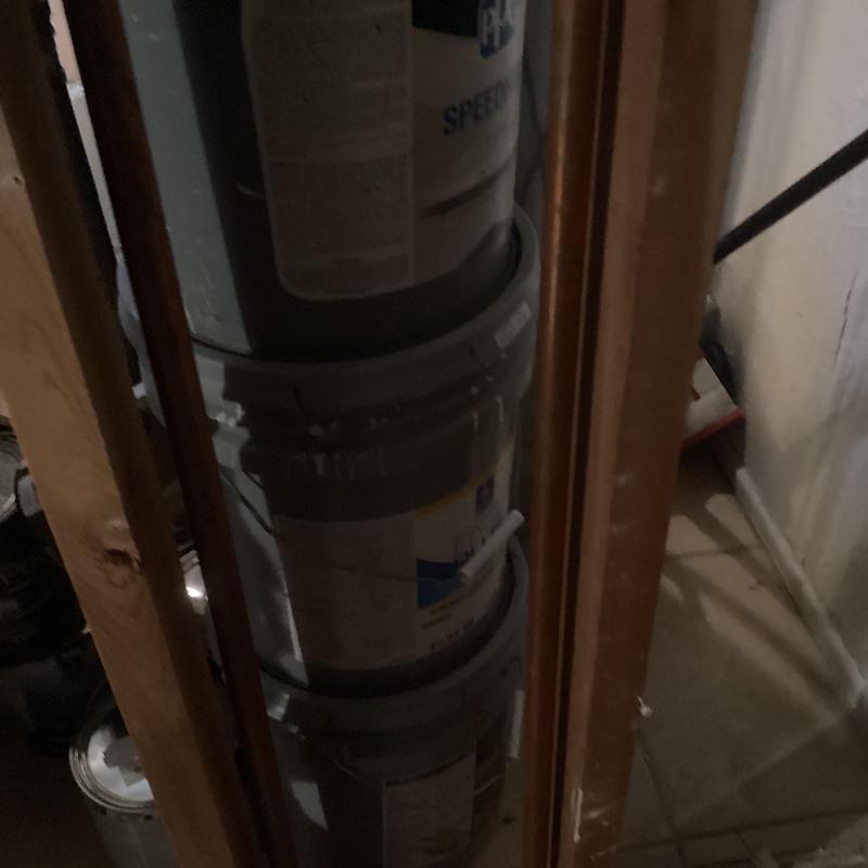 Rheem water heater tank with surrounding piping