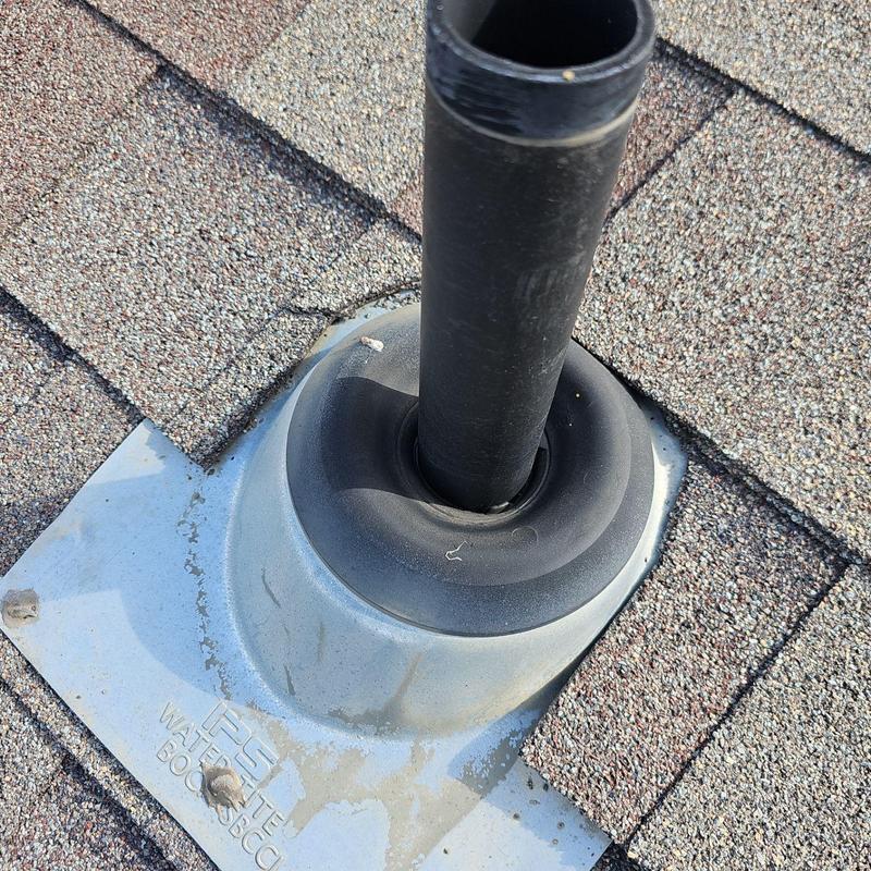 Shingle pipe jack with rubber seal on roof shingles