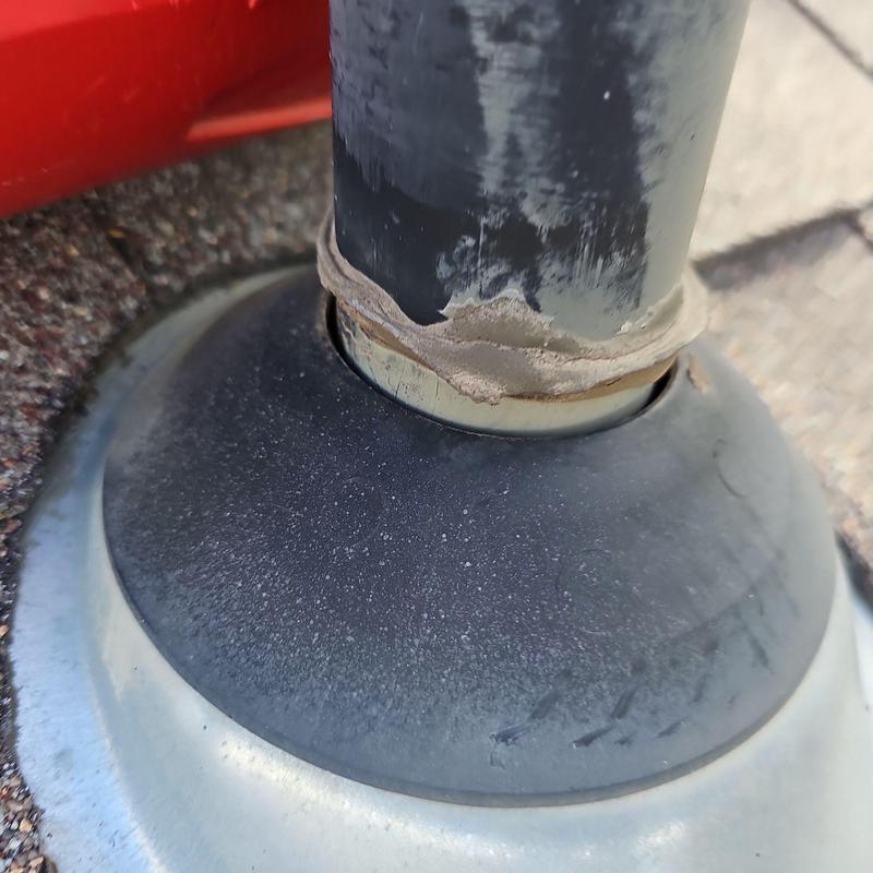 Shingle pipe jack with sealant on roof shingles