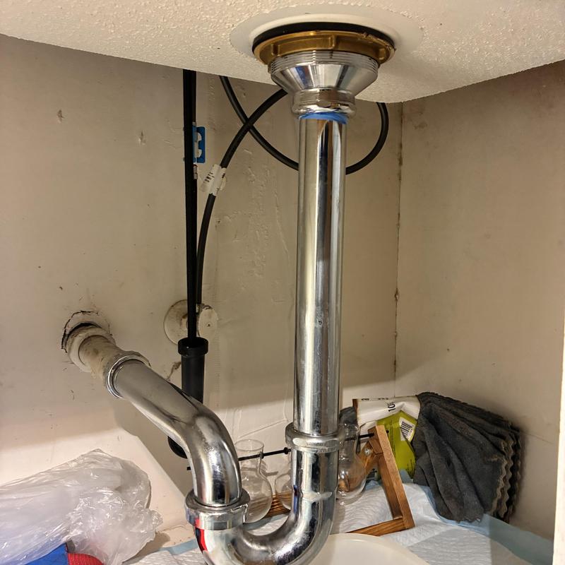 Sink drain pipe and P-trap installation under cabinet