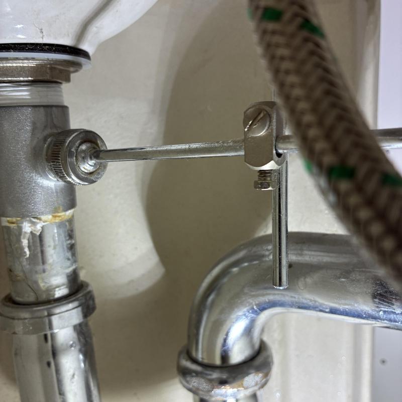 Lavatory sink pop-up assembly nut adjustment close-up