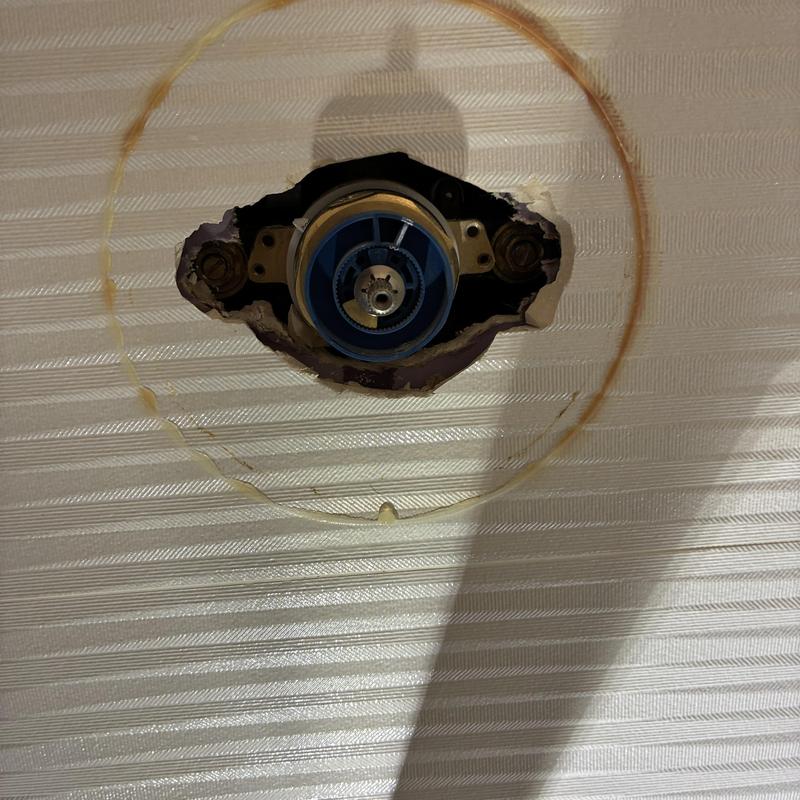 Shower valve cartridge housing exposed in repair site