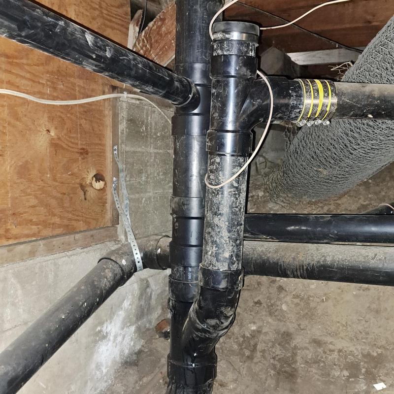 ABS drain pipes under basement with clamps ABS drain pipes under basement with clamps
