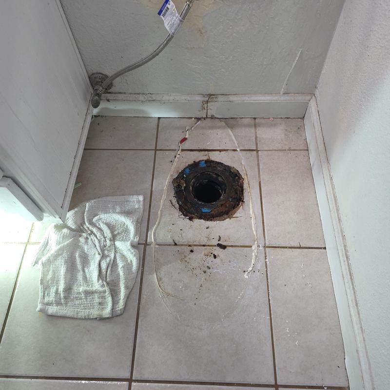 Toilet flange and wax ring on tiled floor removed