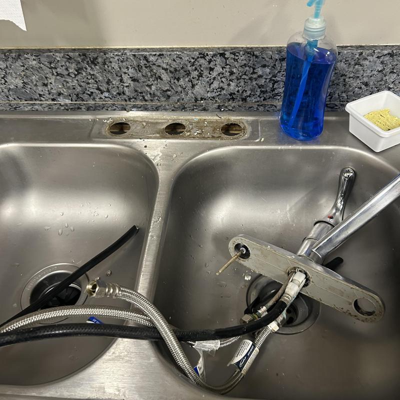 Kitchen sink faucet with supply lines removed for replacement