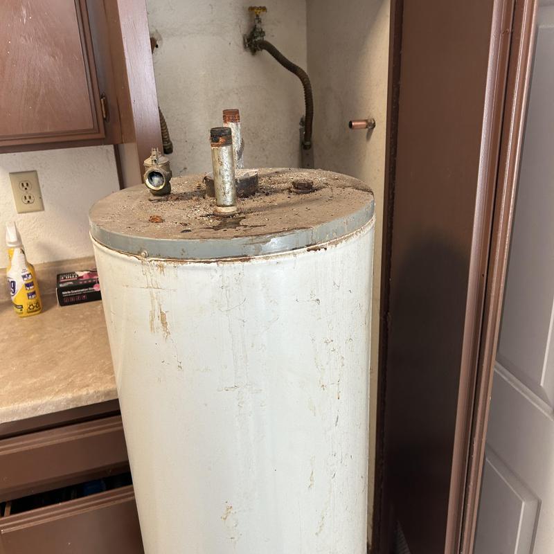Old water heater removal in apartment utility room