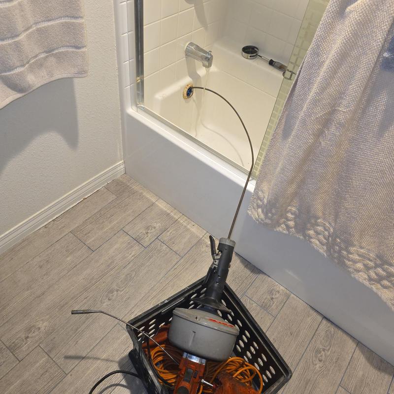 Bathtub drain sewer machine cable clearing clog