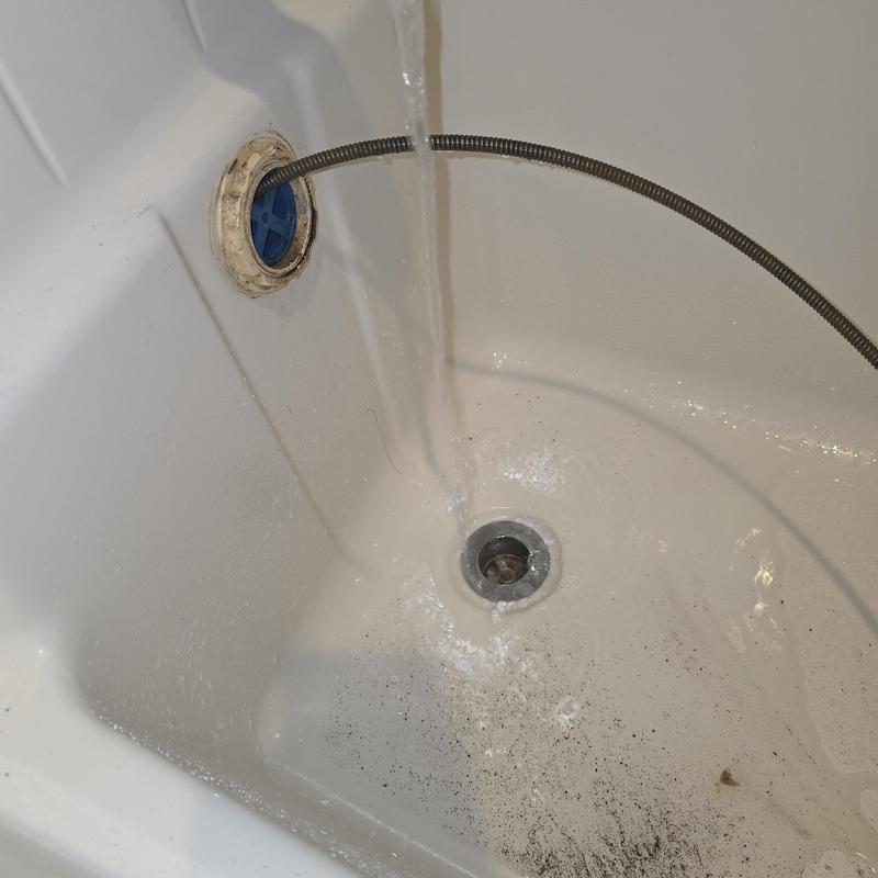 Bathroom tub drain with sewer machine cable cleaning
