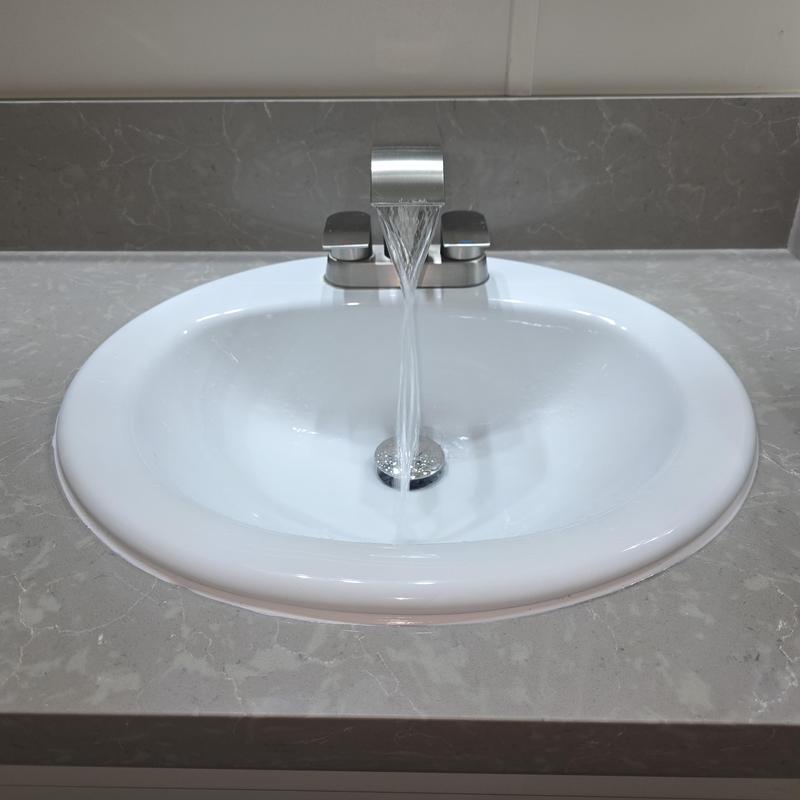 Bathroom sink with flowing faucet and pop-up drain
