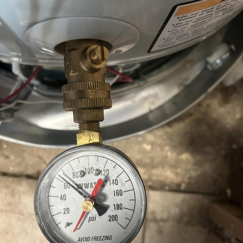 Water heater pressure gauge showing high pressure at 90 psi