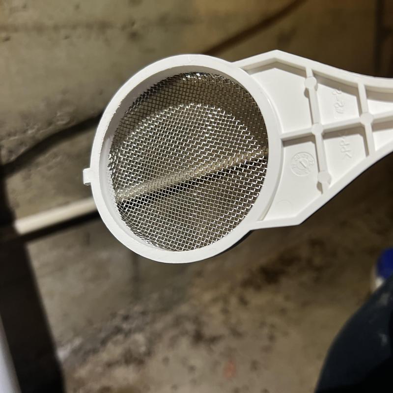Tankless water heater intake filter mesh close-up