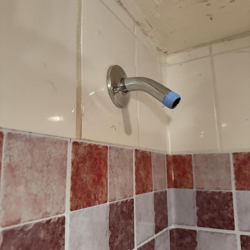 Shower arm with new plumber’s tape on threads