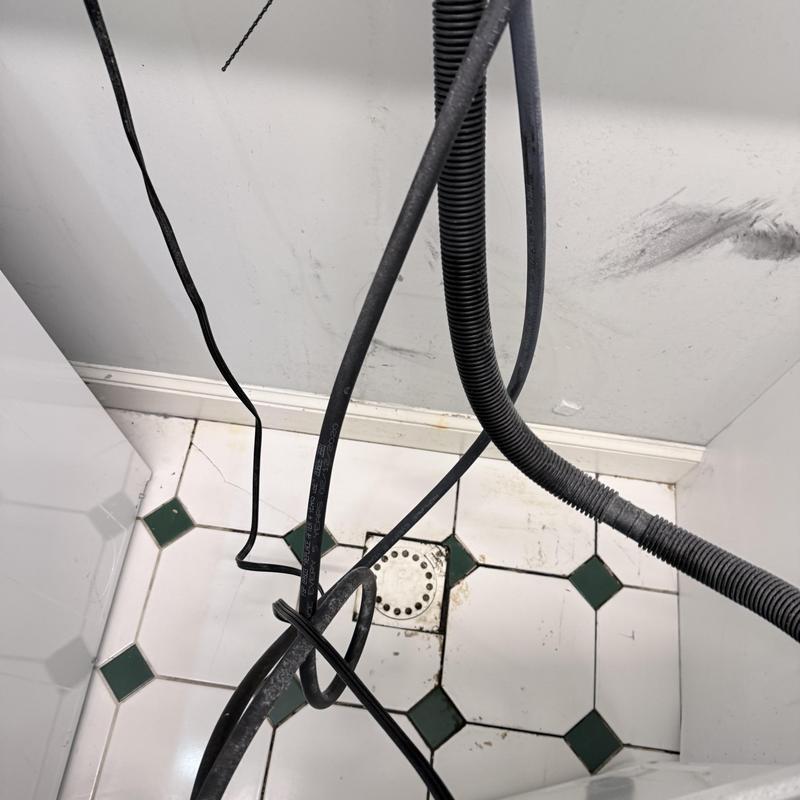 Laundry drain floor with hoses and cables