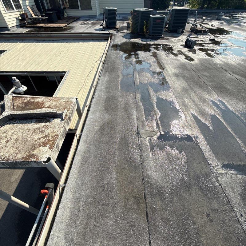 Flat roof membrane with water pooling near HVAC units