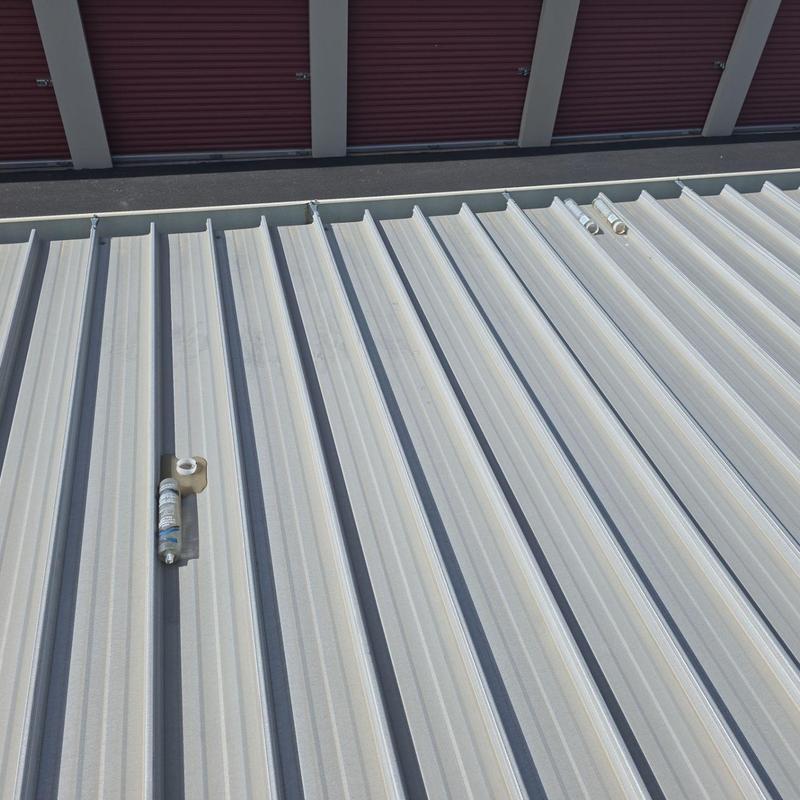 Metal roof above storage units with sealant materials