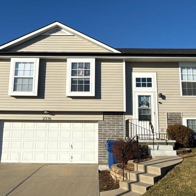 Vinyl siding and seamless aluminum gutters installation on house