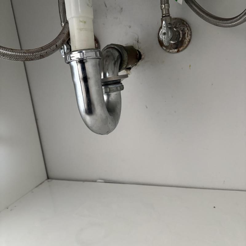 Bathroom sink chrome P-trap under cabinet Bathroom sink chrome P-trap under cabinet