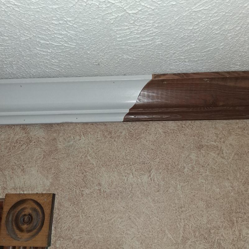 Crown moulding installation with wood and white trim Crown moulding installation with wood and white trim