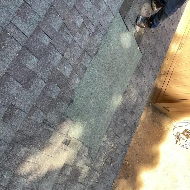 Roof shingles storm damage patch on residential roof