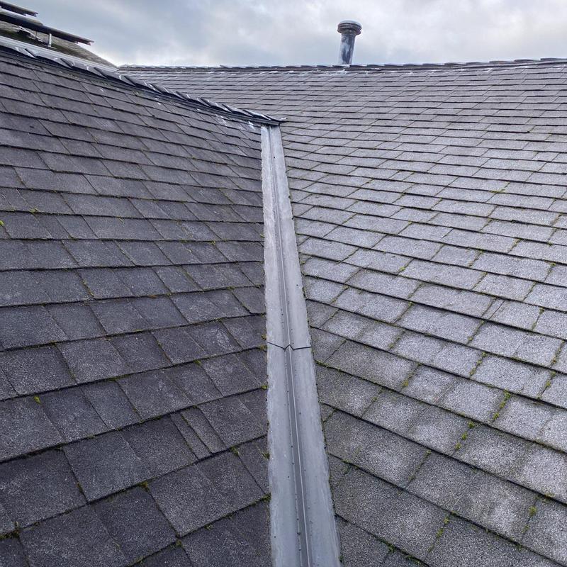 Roof valley with moss buildup before cleaning