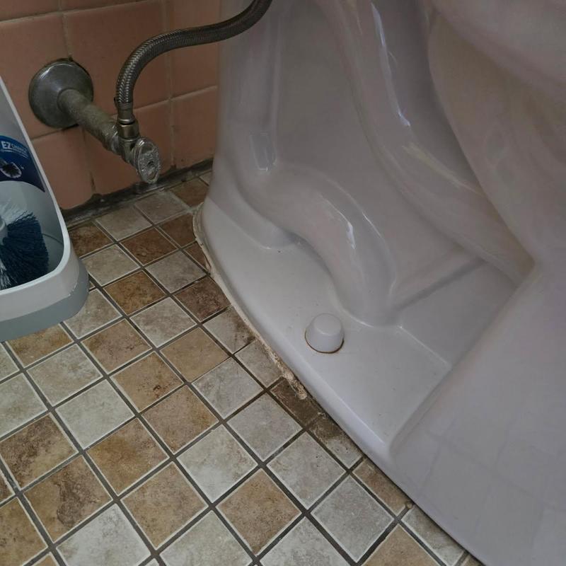 Toilet base resealed with new caulking and wax ring