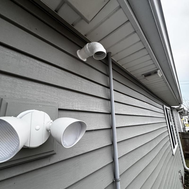 Water heater vent pipe on house exterior wall