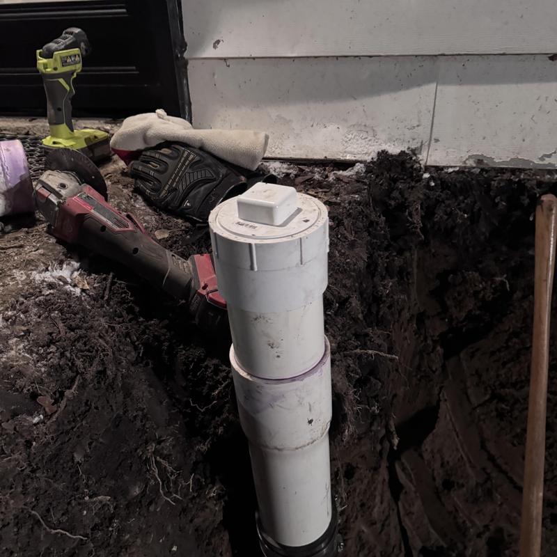 Cast iron sewer cleanout and PVC drain installation