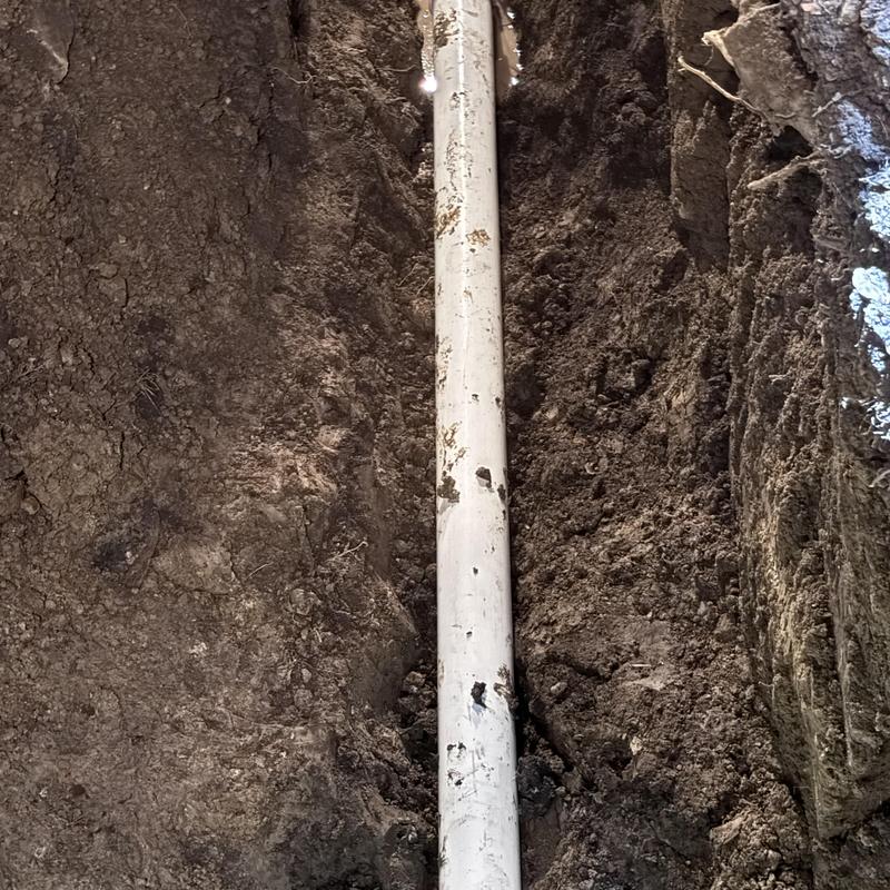 Cast iron sewer pipe with cleanout installation in trench