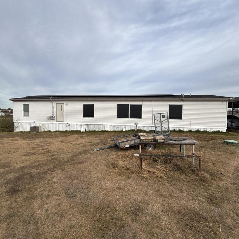 Landing with handrails and steps at mobile home exterior