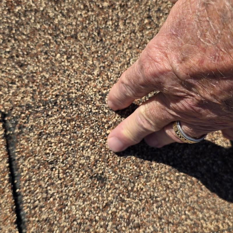 Asphalt shingle roof with hail damage close-up