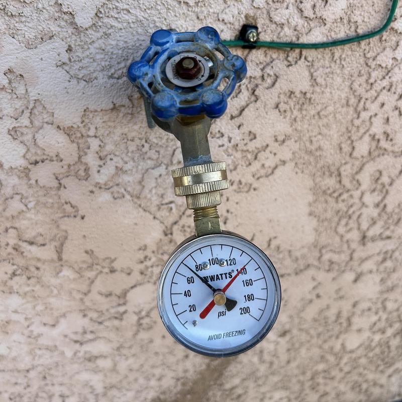 Pressure gauge and valve on outdoor water line