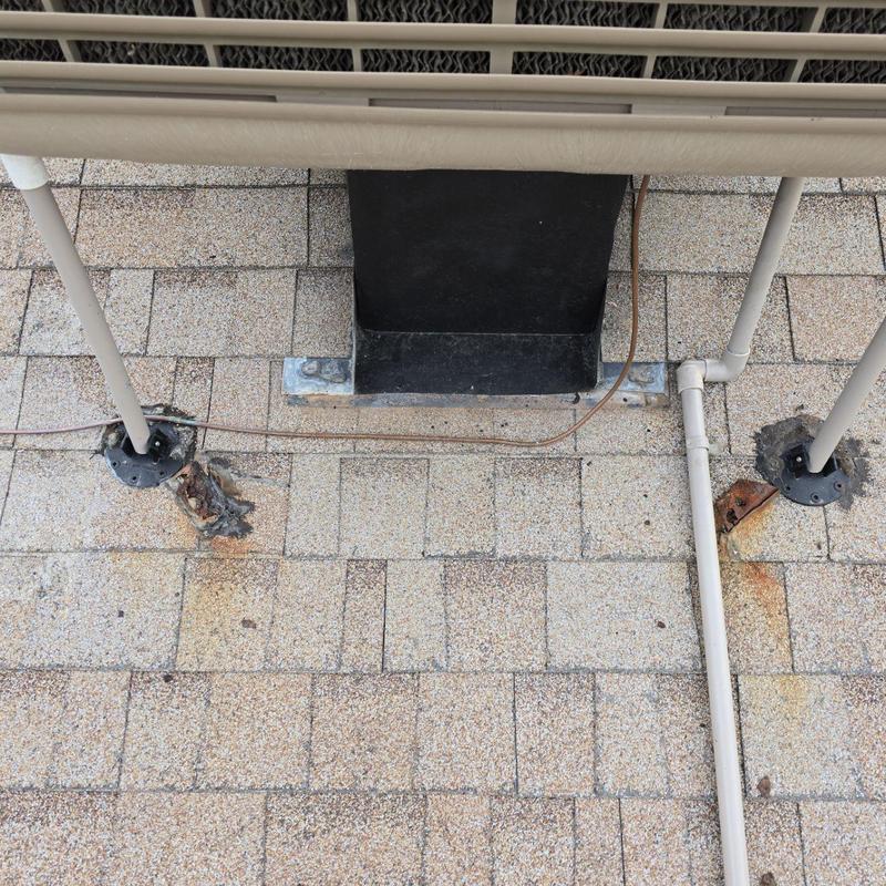 Swamp cooler legs resealed with silicone on shingle roof