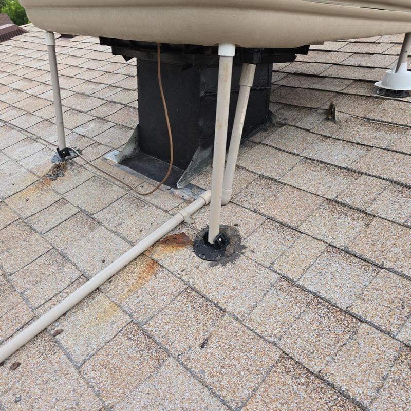 Swamp cooler legs resealed with silicone on shingle roof