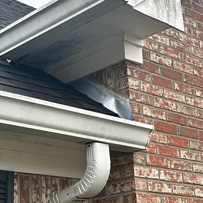 Gutter and roof edge flashing on brick exterior