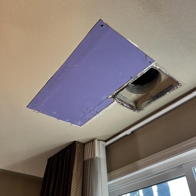 Ceiling patch with exposed duct opening above window