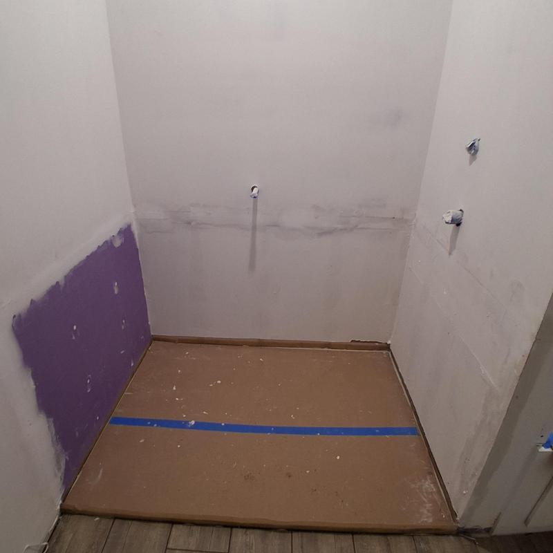 Bathroom tub protective barrier and purple sheetrock panel Bathroom tub protective barrier and purple sheetrock panel