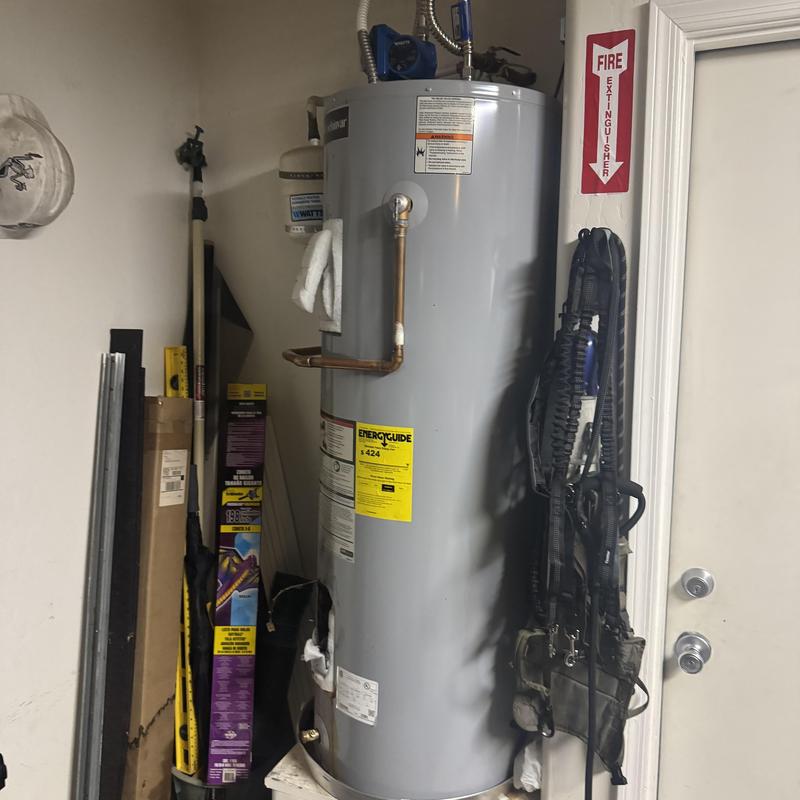 Water heater with copper pipe installation in utility room