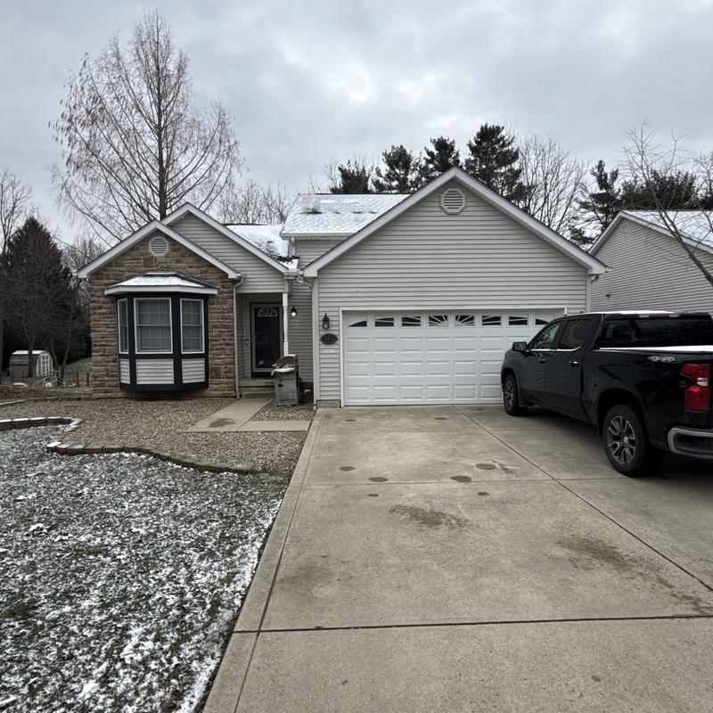 Roof with missing shingles and light snow cover Roof with missing shingles and light snow cover
